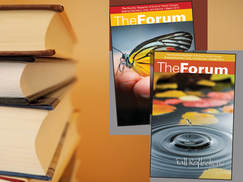 Two Forum magazines next to stack of books